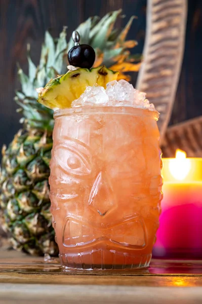 Glass of Jungle Bird cocktail garnished with pineapple wedge