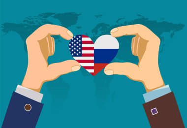 Abd ve Rus bayraklarıyla kalp tutan iki erkek el