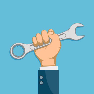 Endüstriyel alet anahtarını elinde tutan adam.