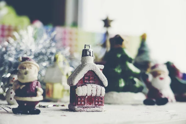 Santa Claus, snowman, houses & snow Sledge miniature model studio shot on colorful background for family, giving, season, Christmas, holiday, new year, travel and gathering concept