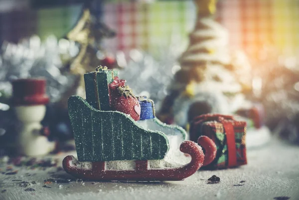 Santa Claus, snowman, houses & snow Sledge miniature model studio shot on colorful background for family, giving, season, Christmas, holiday, new year, travel and gathering concept