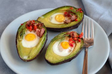 Avokado bacon, kırmızı pul biber ve dereotu ile bıldırcın yumurtası pişmiş.