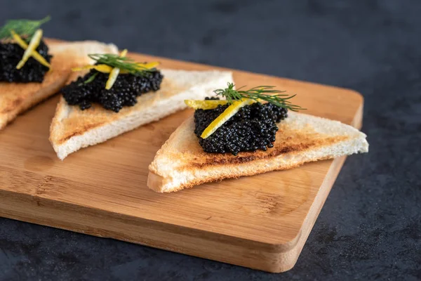 Előétel toast kenyér, citrom tabletta és kapros díszített fekete kaviár — Stock Fotó