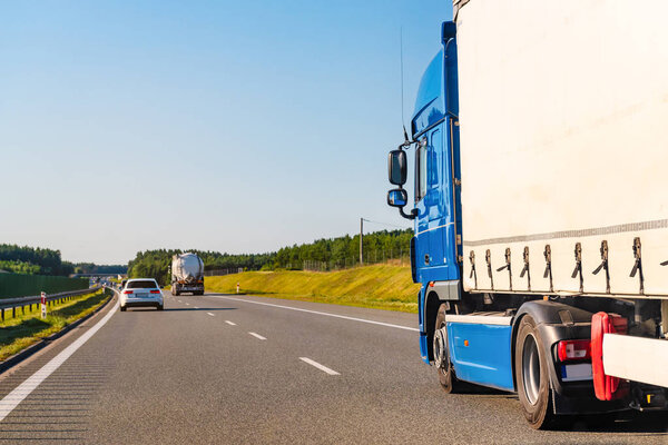 Freight truck on a highway in a rural landscape