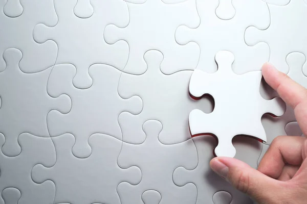 Putting last jigsaw puzzle piece. Solving and completing the task. — Stock Photo, Image