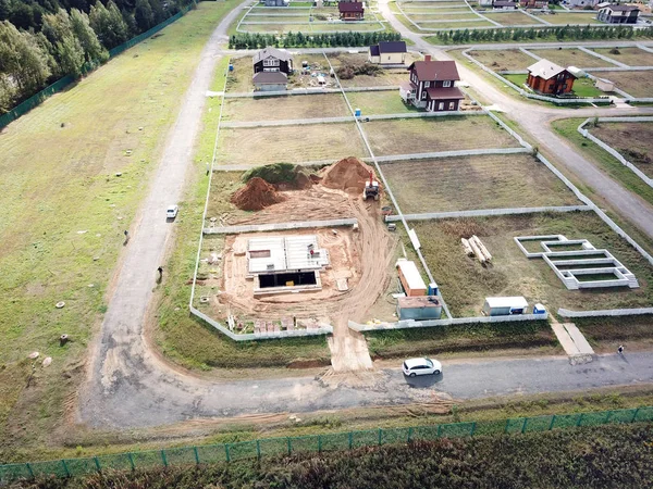 Aeriial view of excavation works and construction area with unfinished houses
