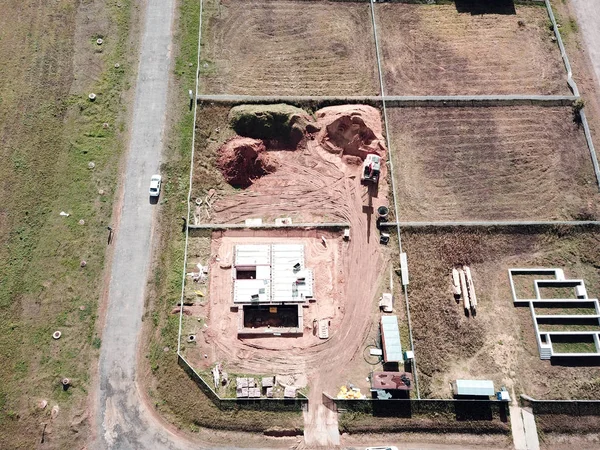 Aerial view of the bulldozer and excavation works while building a new house