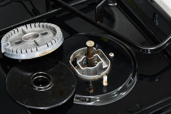 disassembled gas range parts and a temperature sensor for fire prevention