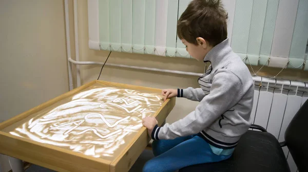 child in the classroom sand therapy