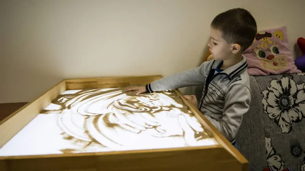 a child in a sand therapy session