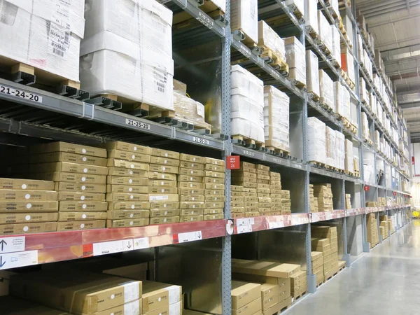 warehouse shelves with boxes in the background