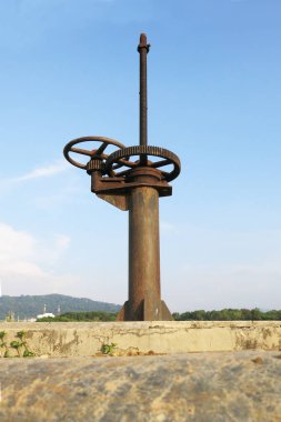 Binanın arka planında paslı metal bir boru var.