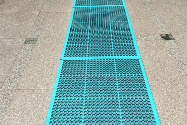 close up of rubber carpet on tiles