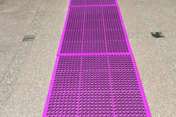close up of rubber carpet on tiles