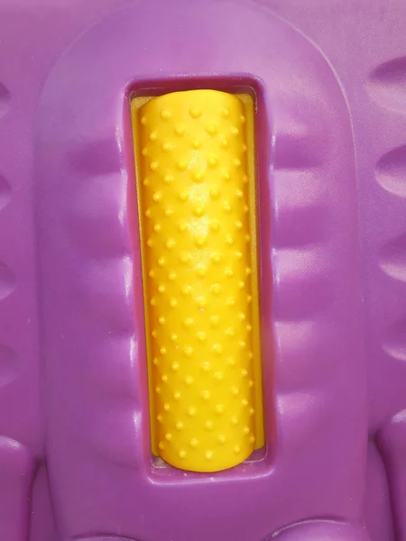 yellow plastic tape with rubber toy, closeup