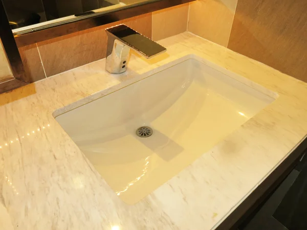 modern bathroom with white sink and water faucet