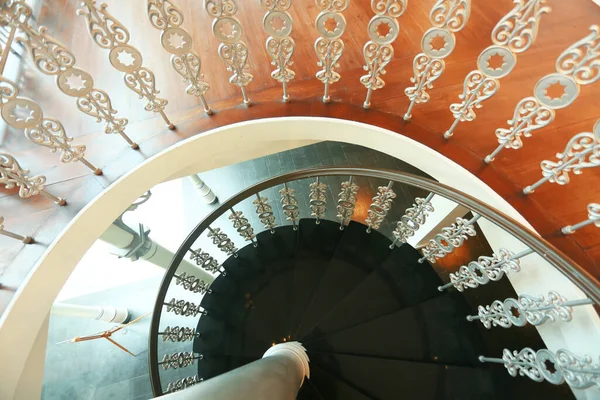 elegant wooden spiral stairs with railings in luxury interior