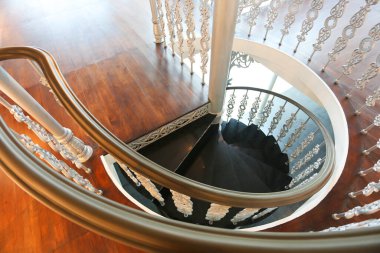 elegant wooden spiral stairs with railings in luxury interior