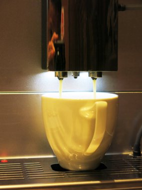 close-up view of cup of coffee and coffee machine