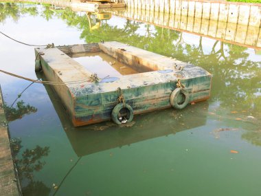 Old tires at the marina on sea background.