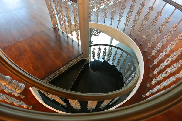 elegant wooden spiral stairs with railings in luxury interior