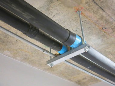 construction site with pipes inside industrial building 