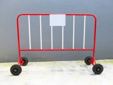 Metal moving fence on concrete wall background.