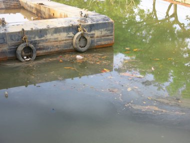 Old tires at the marina on sea background.