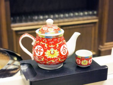 Ceramic teapot on stone plate.