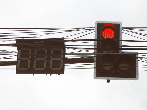 Road sign and traffic lighting on the road.