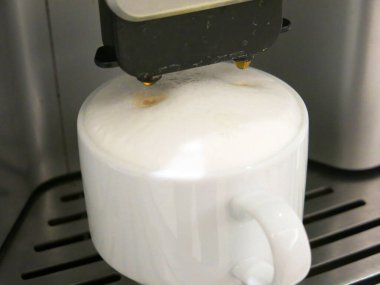 close-up view of cup of coffee and coffee machine
