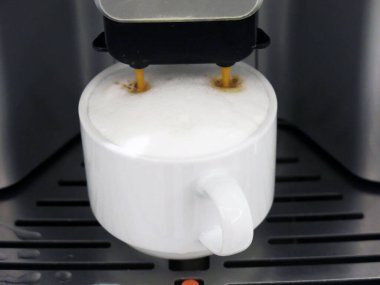 close-up view of cup of coffee and coffee machine