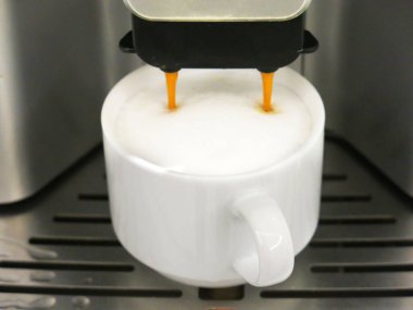 close-up view of cup of coffee and coffee machine