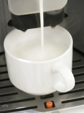 close-up view of cup of coffee and coffee machine
