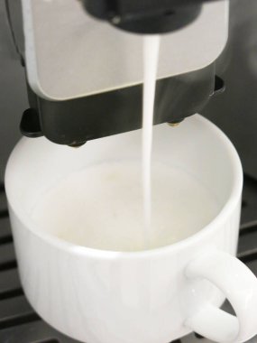 close-up view of cup of coffee and coffee machine