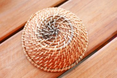 close-up view of handmade wicker basket on wooden background