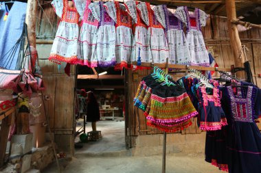 Thai culture souvenirs hanging in shop market.