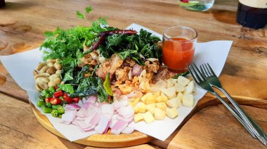close-up view of plate with delicious meal on wooden table