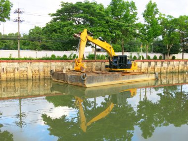 Backhoe cars on floating capital.