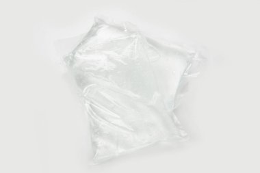 white plastic bag with a lid on a gray background
