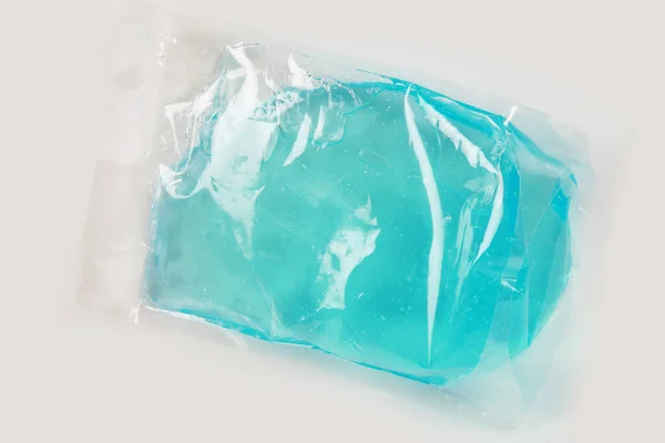 plastic bag with colored liquid on white background