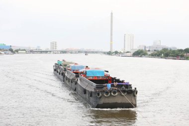 cargo ships on canal and urban cityscape