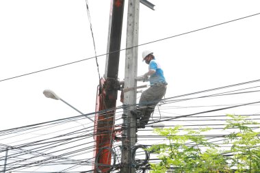 The electricity worker climbing on the tower.