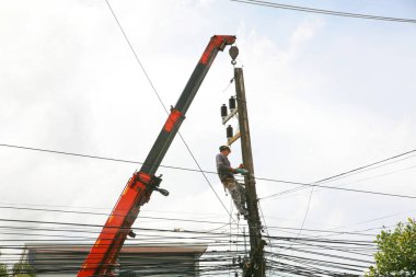 The electricity worker climbing on the tower.