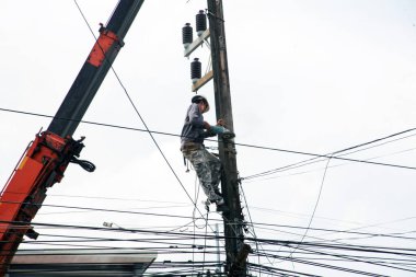 The electricity worker climbing on the tower.