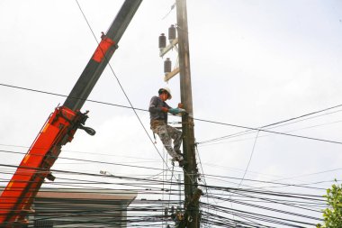 The electricity worker climbing on the tower.