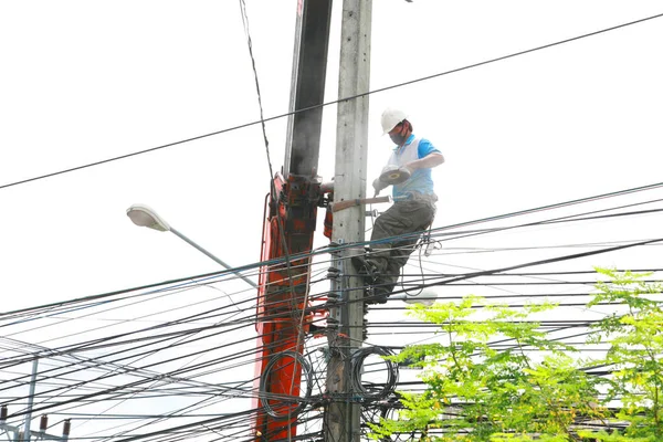 The electricity worker climbing on the tower.