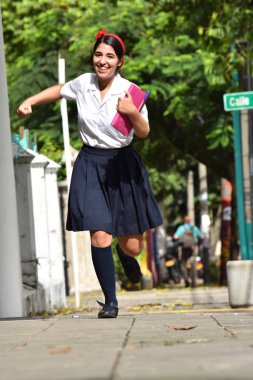 Şirin Kolombiya kız öğrenci defter ile çalışan