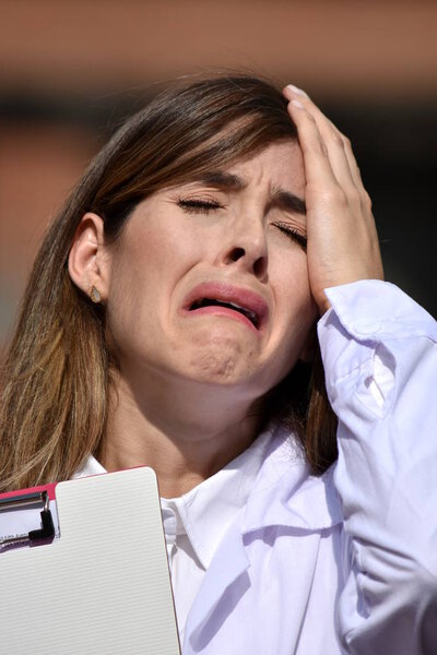 Colombian Female Medical Professional And Anxiety With Clipboard