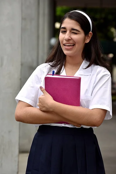 Catholic Female Student Winking With Notebook